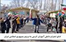 ادای احترام دانش آموزان کرجی به پرچم مقدس جمهوری اسلامی ایران